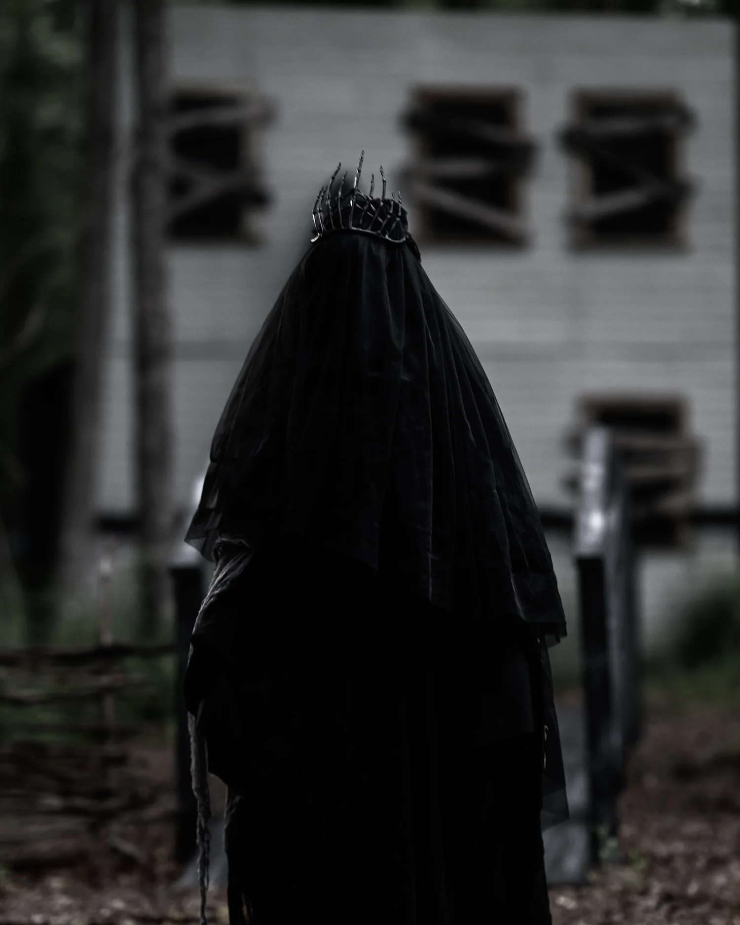 Scare actor lit in red inside a Nightmare's Gate scene